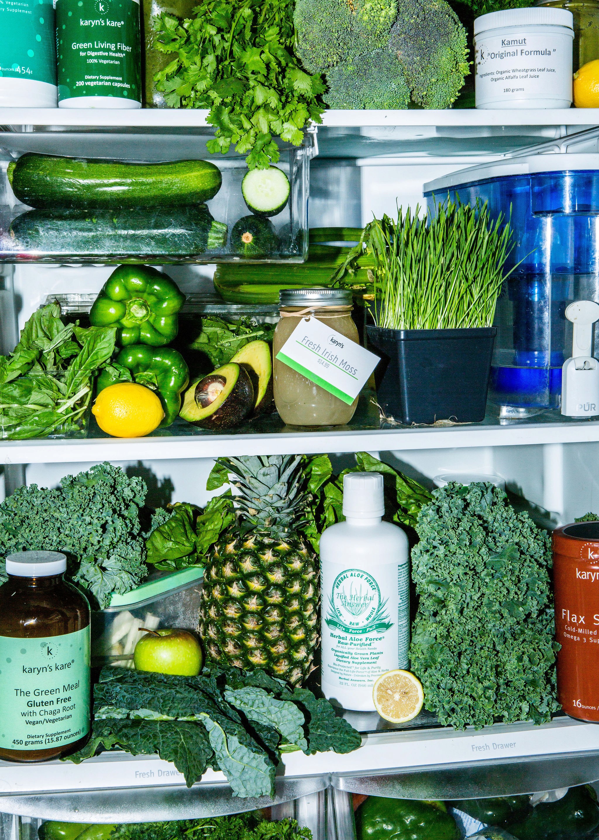 Woman posing by a gas station sign at night