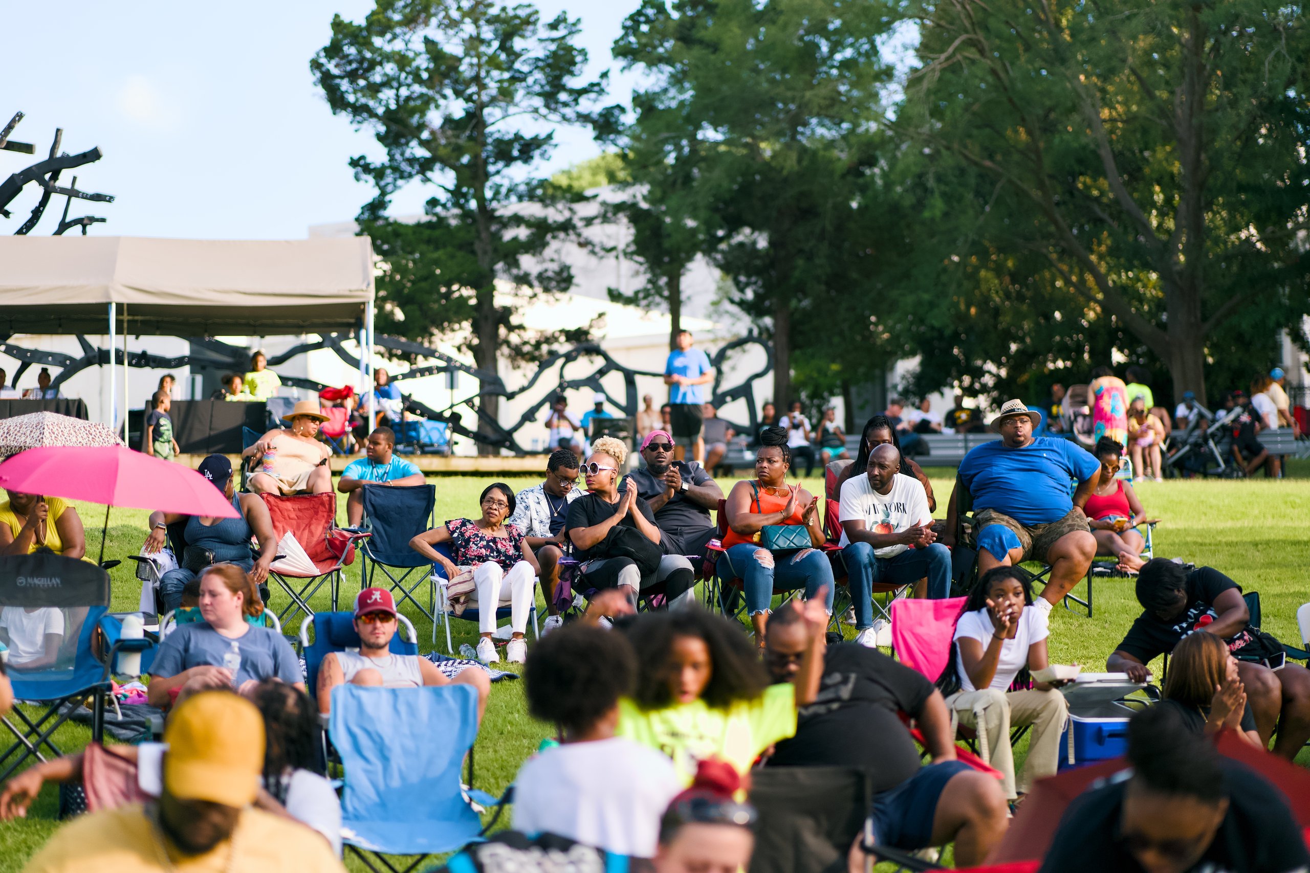 Crowd in lawn chairs watches the Youth Talent Show at Overton Park in Memphis