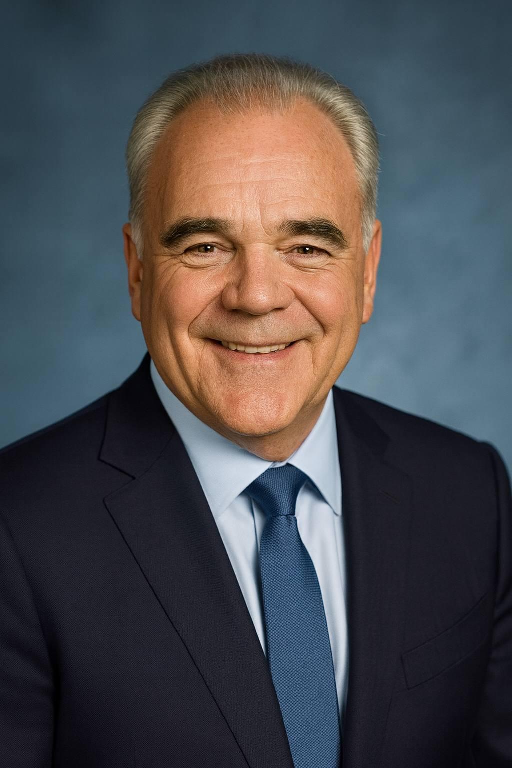 Portrait of a woman with straight long hair, in a dark t-shirt, set against a neutral backdrop.