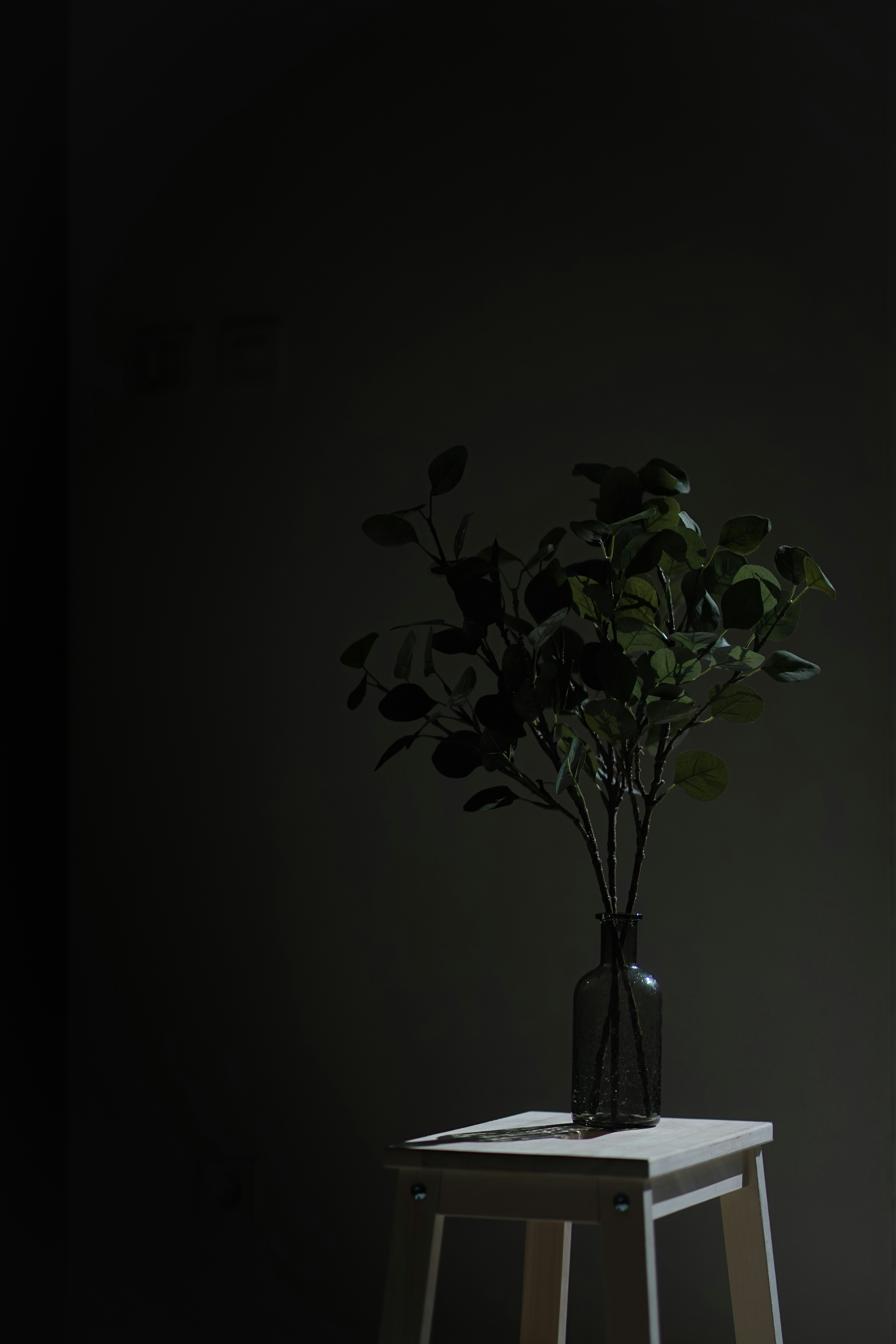 The image features a stylized figure with a unique, abstract design. The main subject appears to be a humanoid form with a wooden texture, wearing a blue robe.