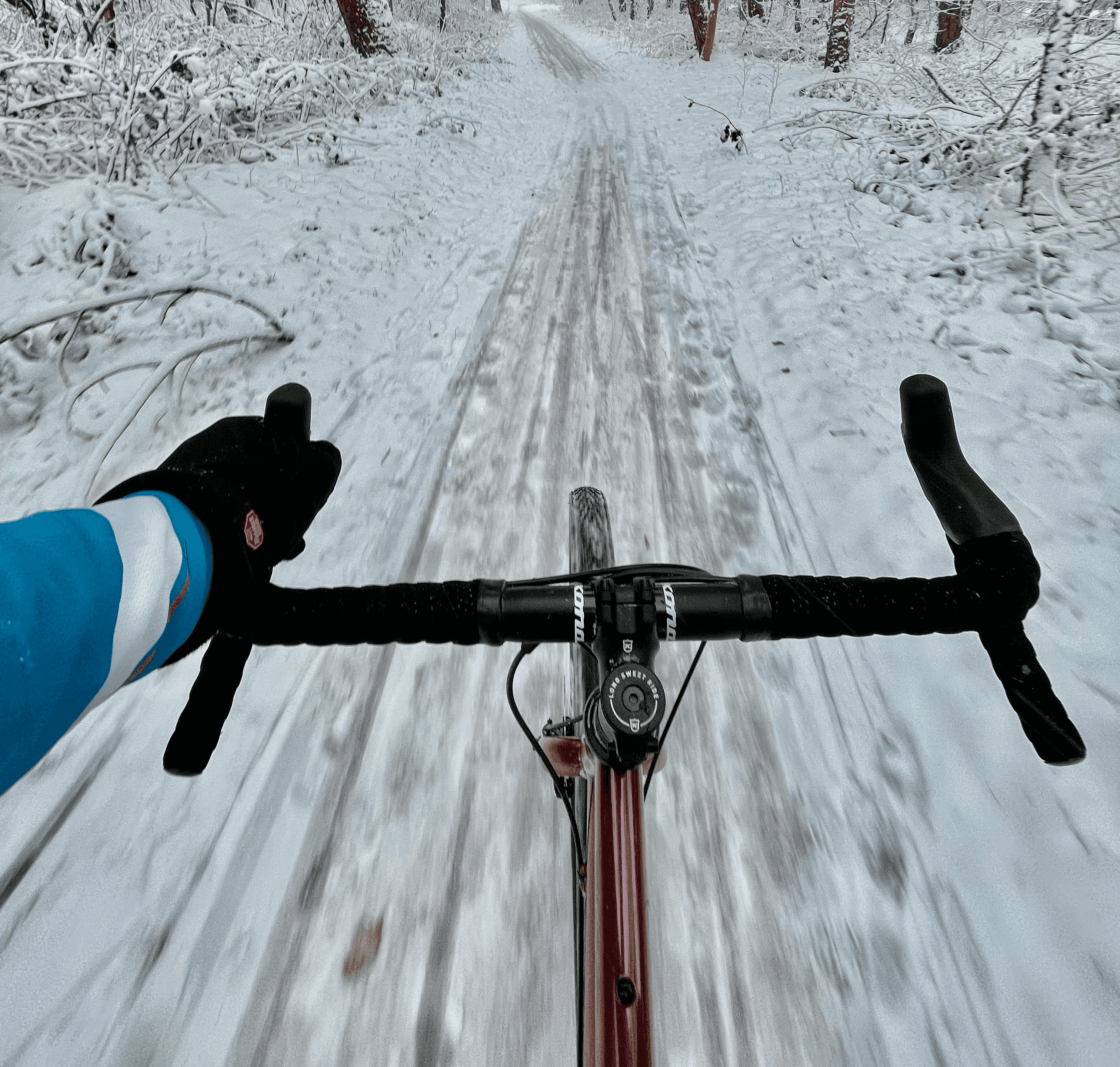 Cyclist training on a gravel path covered in snow