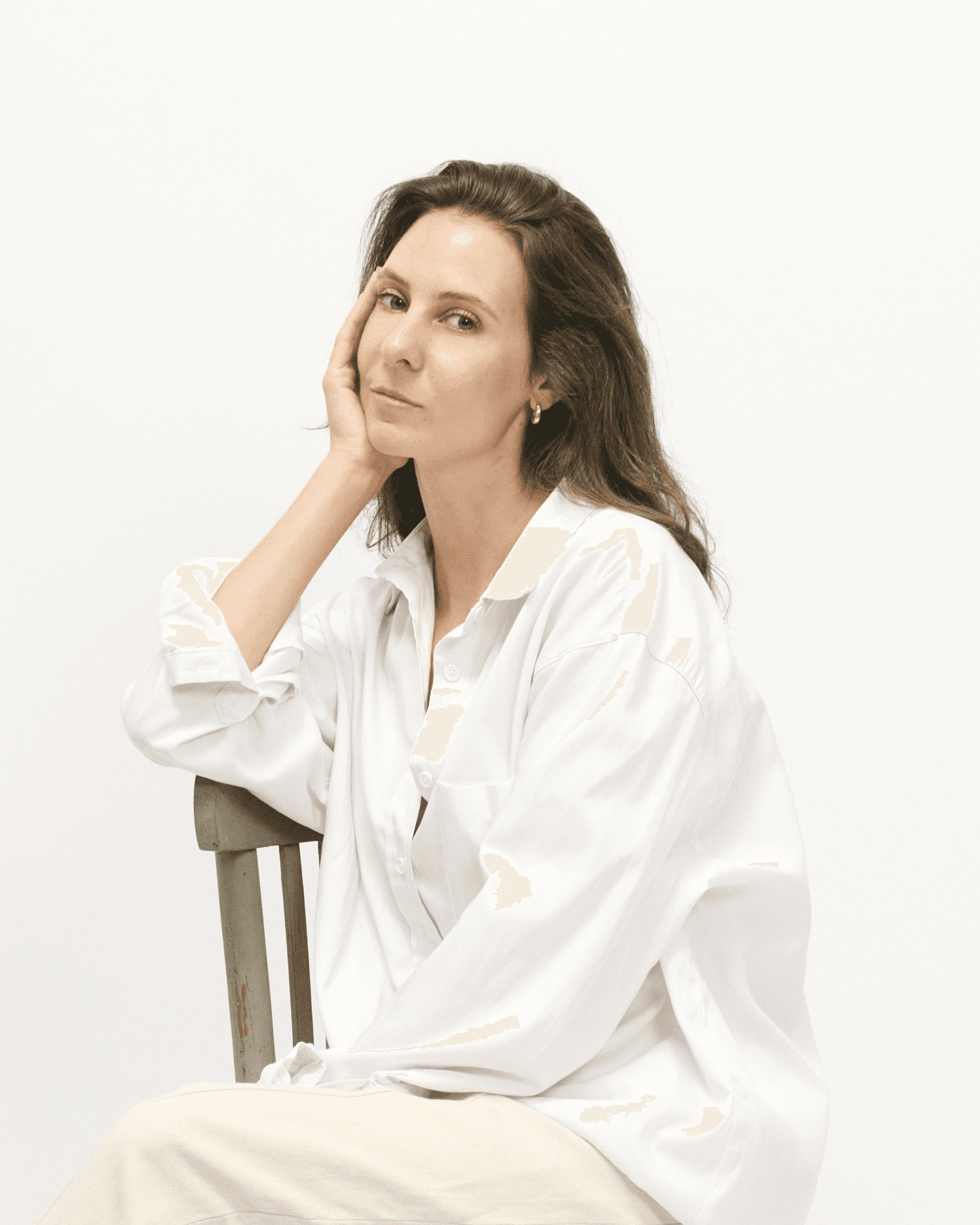 Headshot of woman interior designer in white.