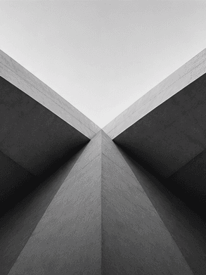Converging architectural lines and forms moving towards a common focal point, representing alignment and shared direction.