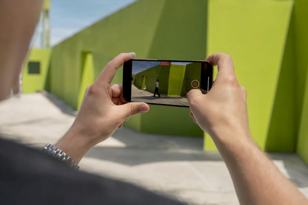Hands filming a video ad with a smartphone