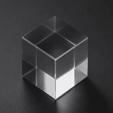 Glass cube on a dark matte office table