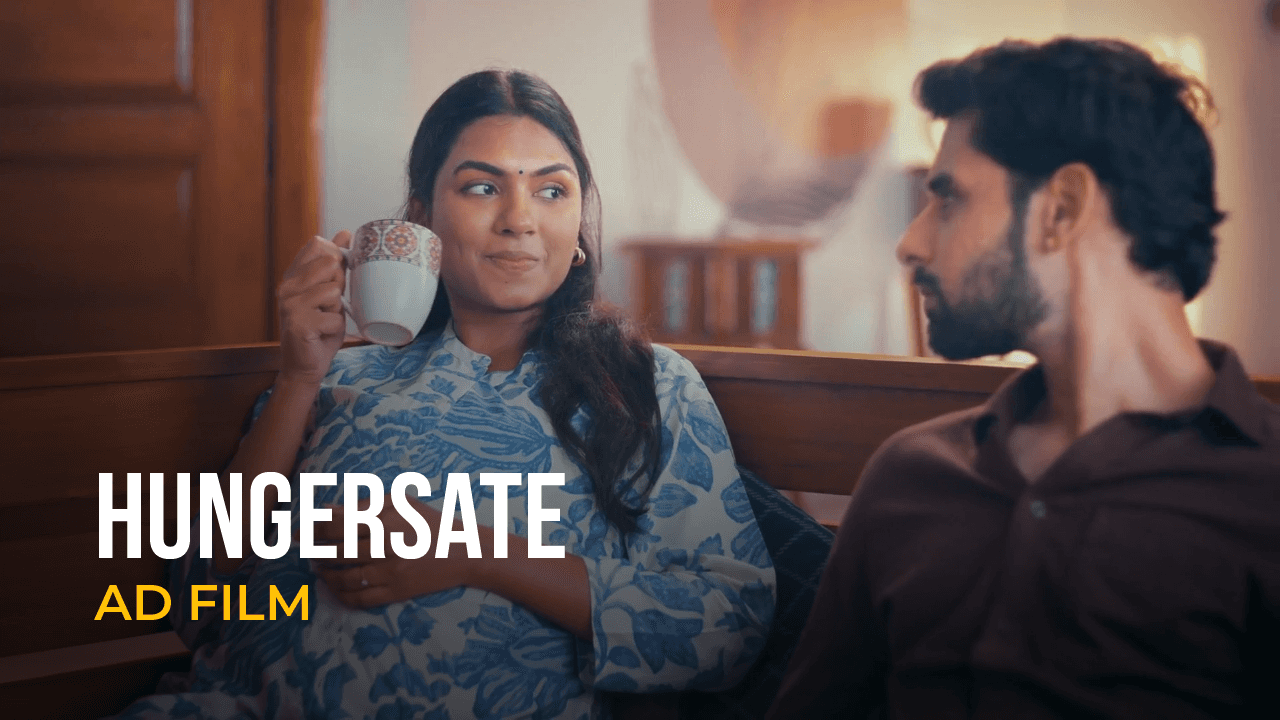Couple in conversation inside a home featured in a Hungersate advertisement film.