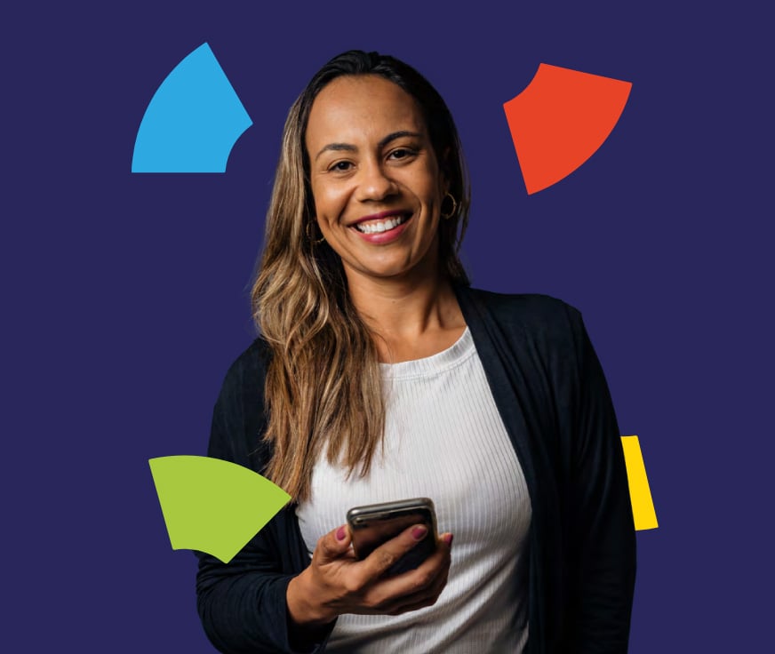 A person holding a phone and smiling.