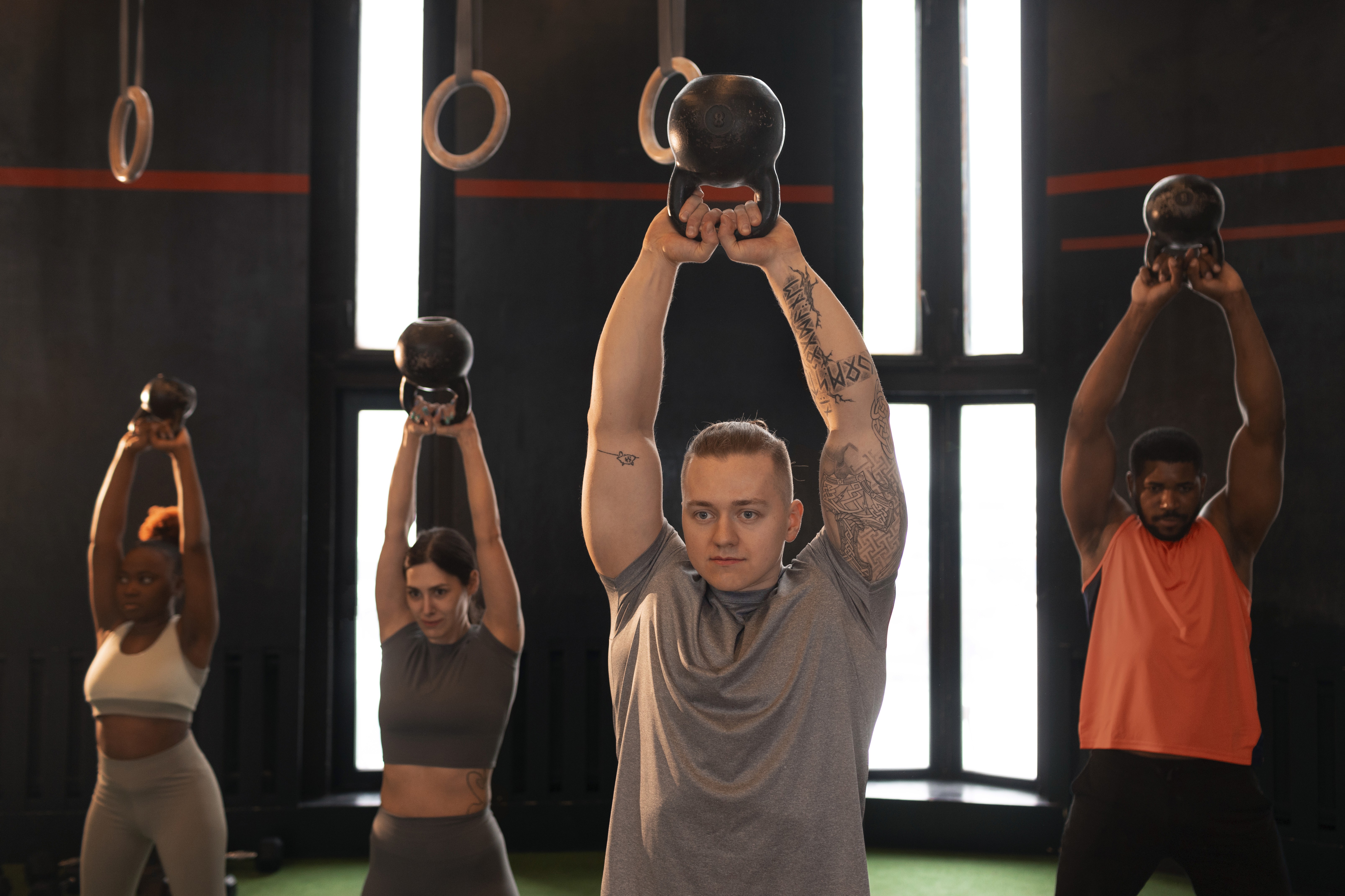 A group of women doing exercises with dumbbells