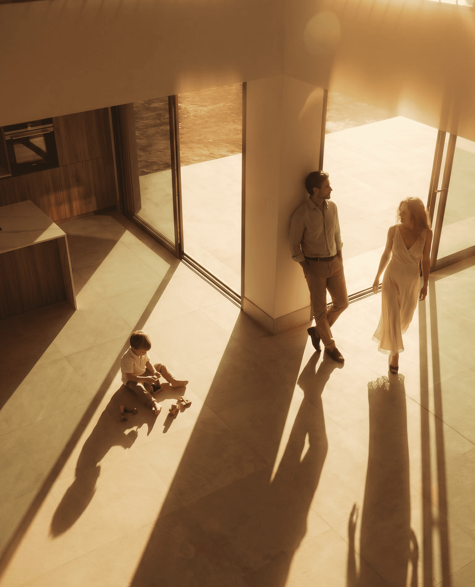 A man and woman walk through a modern, minimalistic hallway with light wooden floors. They seem engaged in conversation, conveying a professional tone.