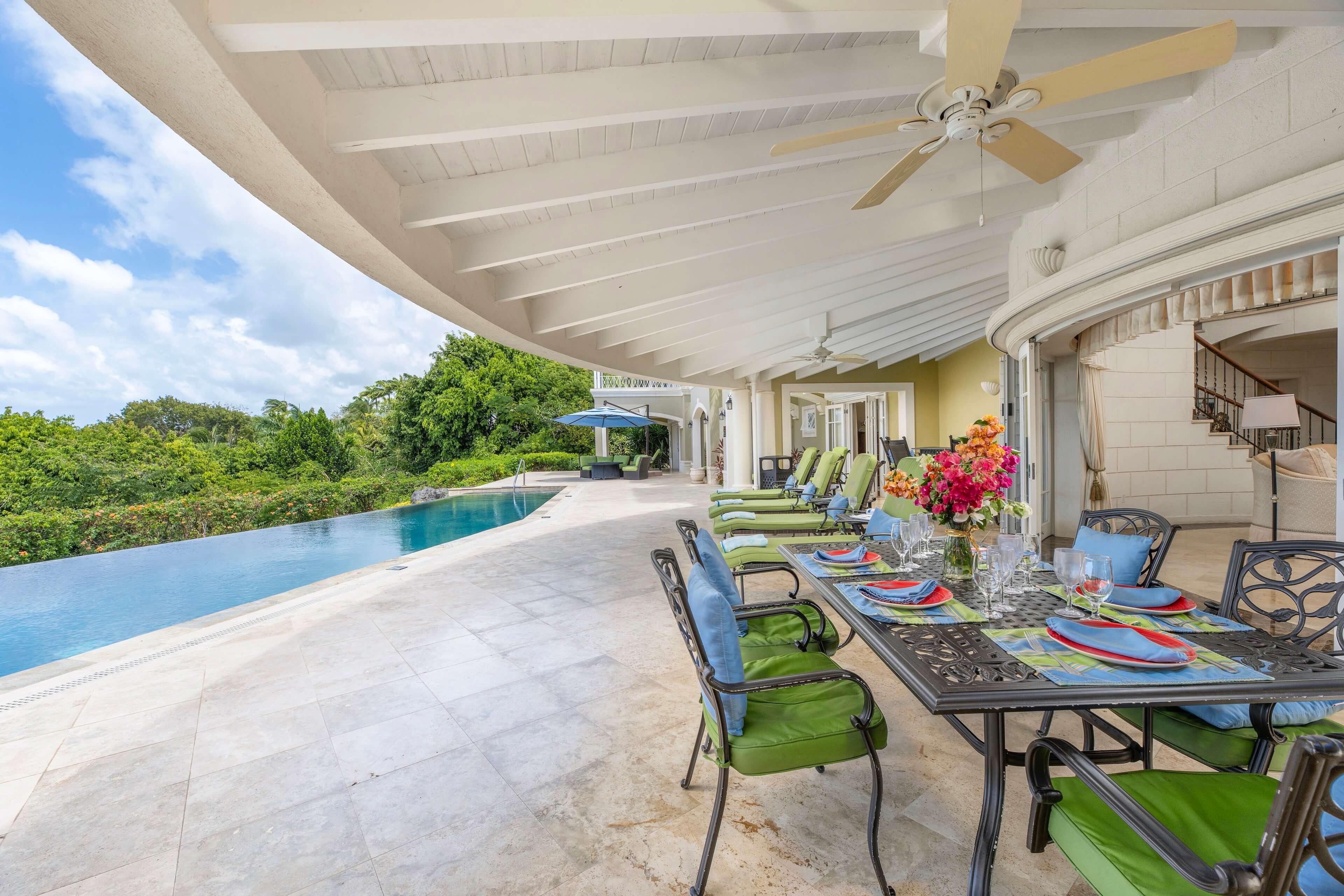 Outdoor patio with dining area overlooking an infinity pool.