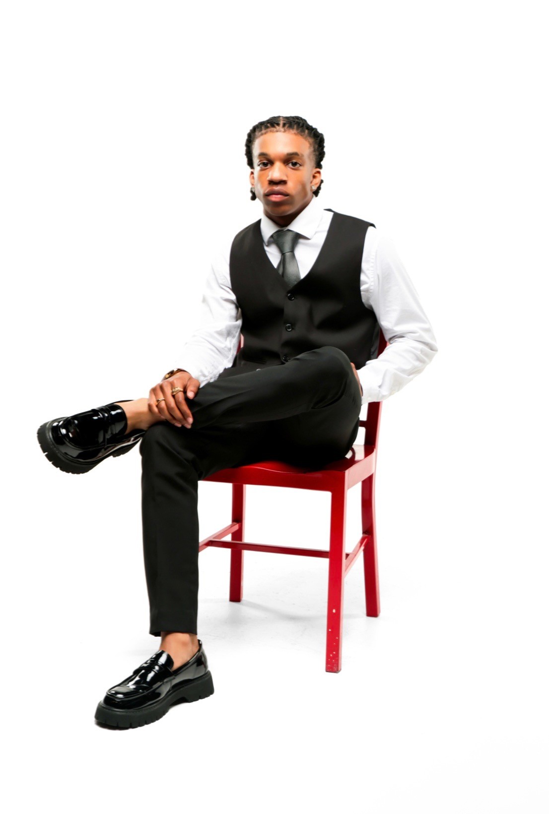 Portrait of Braylen seated in a red chair