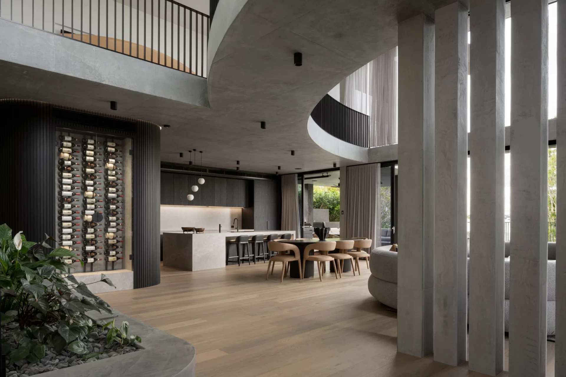 Aerial view of a stylish restaurant with a marble-topped bar, wooden floor, and beige cushioned booth seating. Tables set elegantly, evoking a cozy, upscale ambiance.