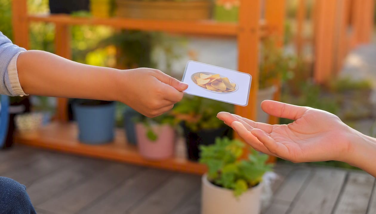 Child handing picture communication card
