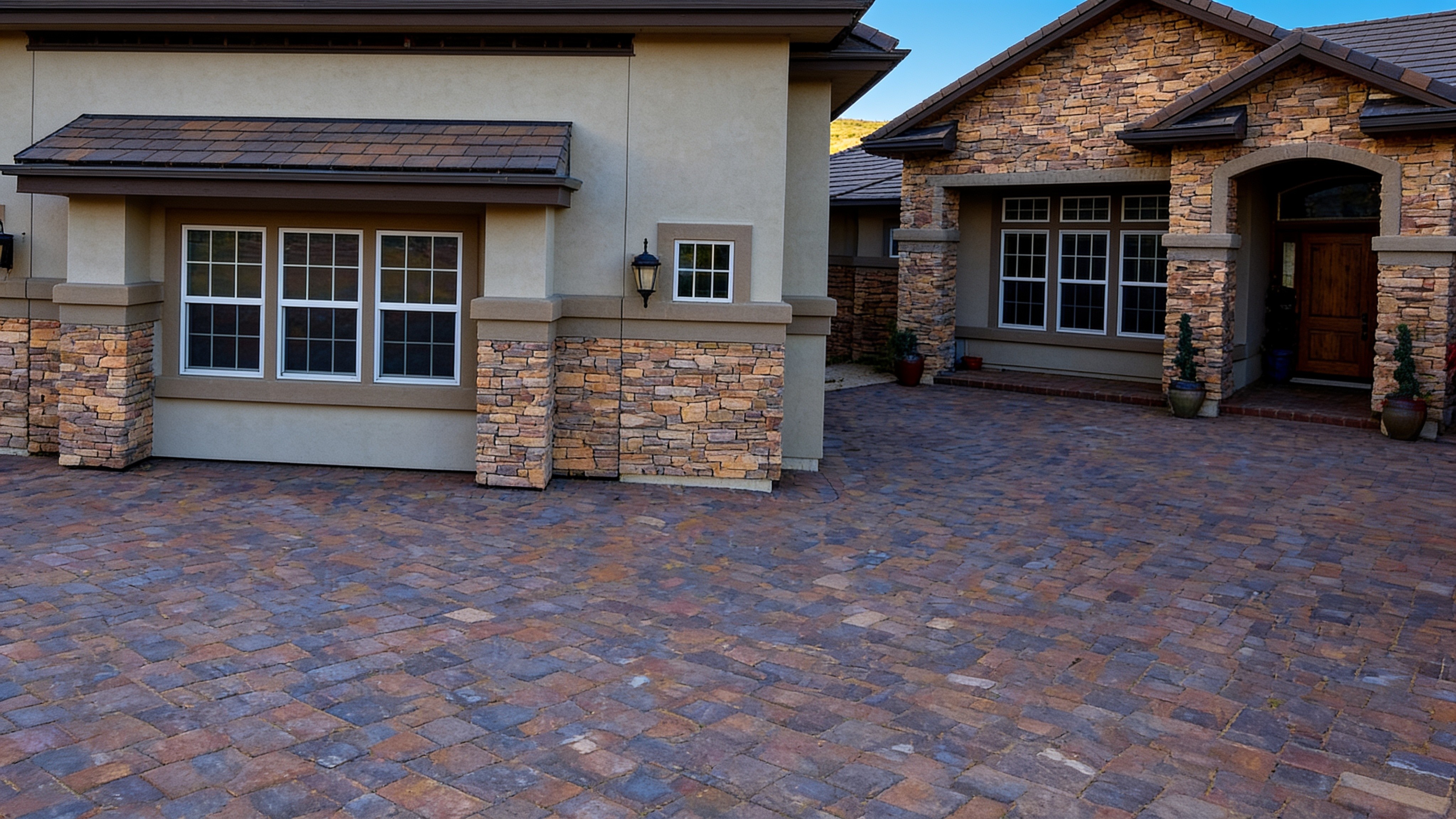 Stucco garage door blending into a home's stone and stucco exterior