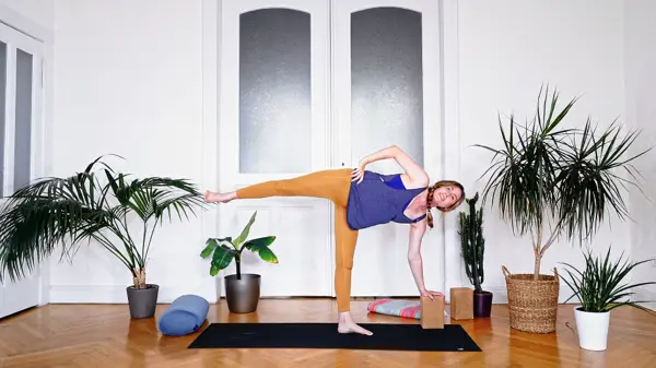 Pregnant woman in a standing yoga balance pose – prenatal yoga class to improve circulation and reduce fluid retention through Ujjayi breathing and targeted movement