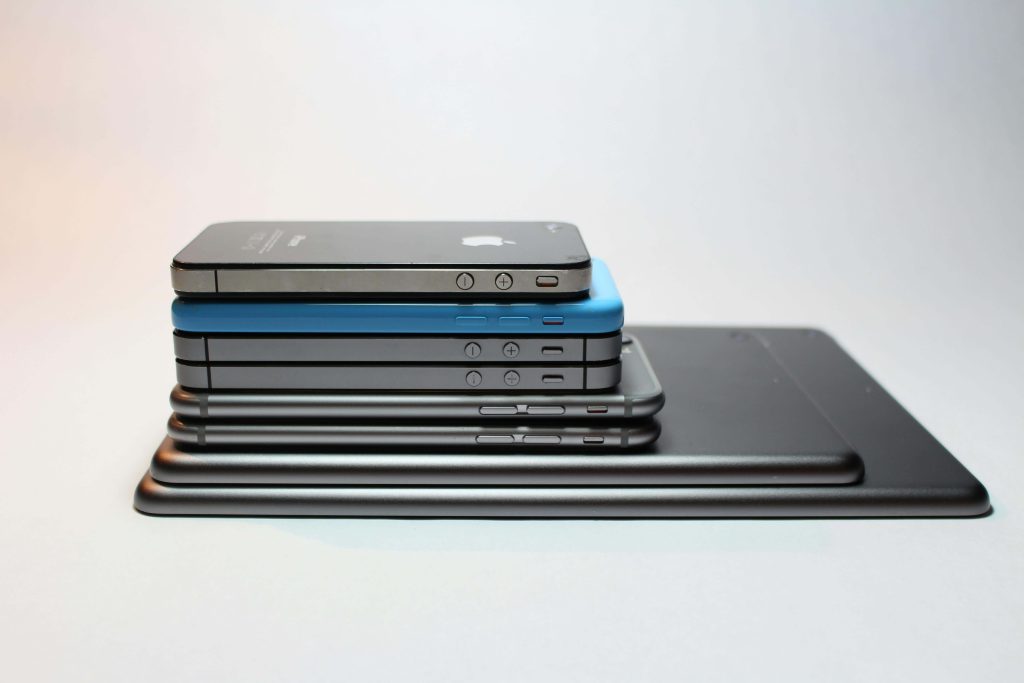 iPhones and iPads stacked on top of each other.