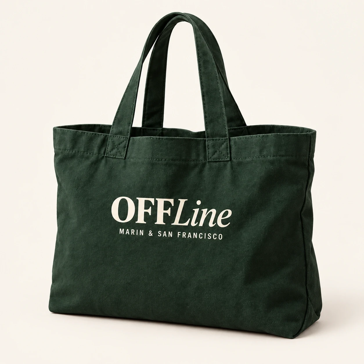Forest green canvas tote with cream OFFLine wordmark.