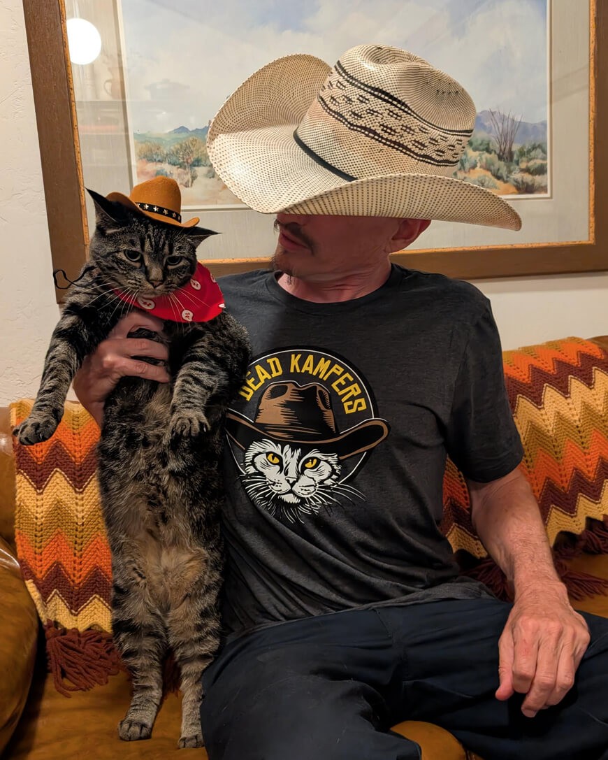Roscoe Mittens the cat with Donny Campion, both wearing cowboy hats.