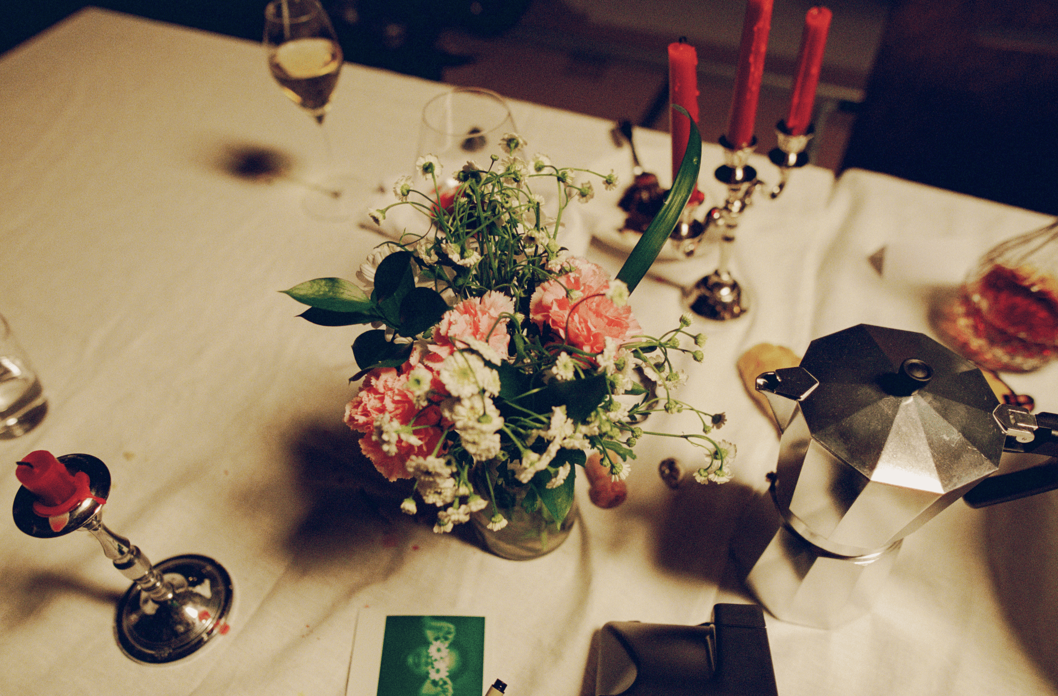 A decorative floral arrangement spills over a table draped in red fabric, creating an elegant atmosphere.