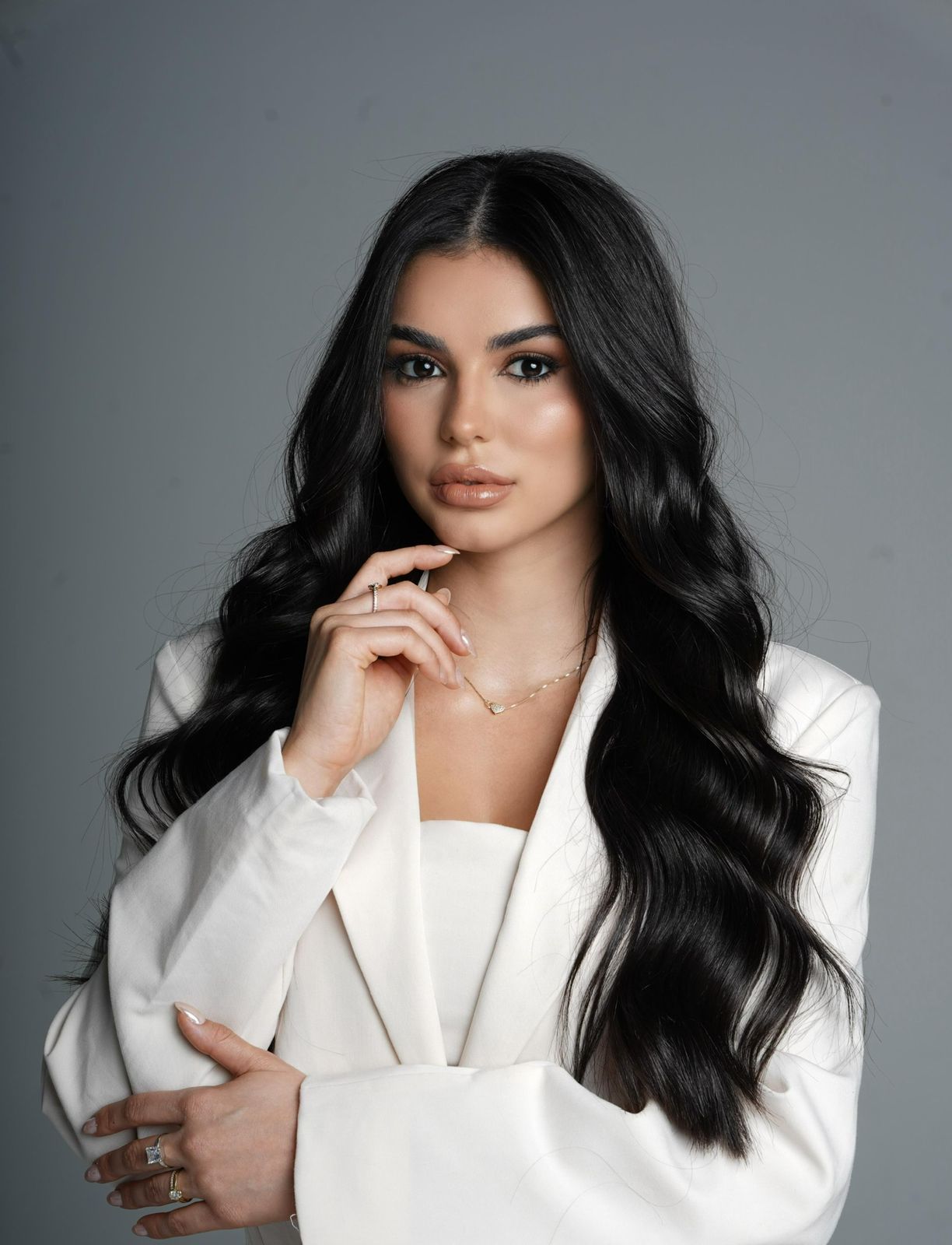 man in black suit jacket and black pants sitting on green sofa