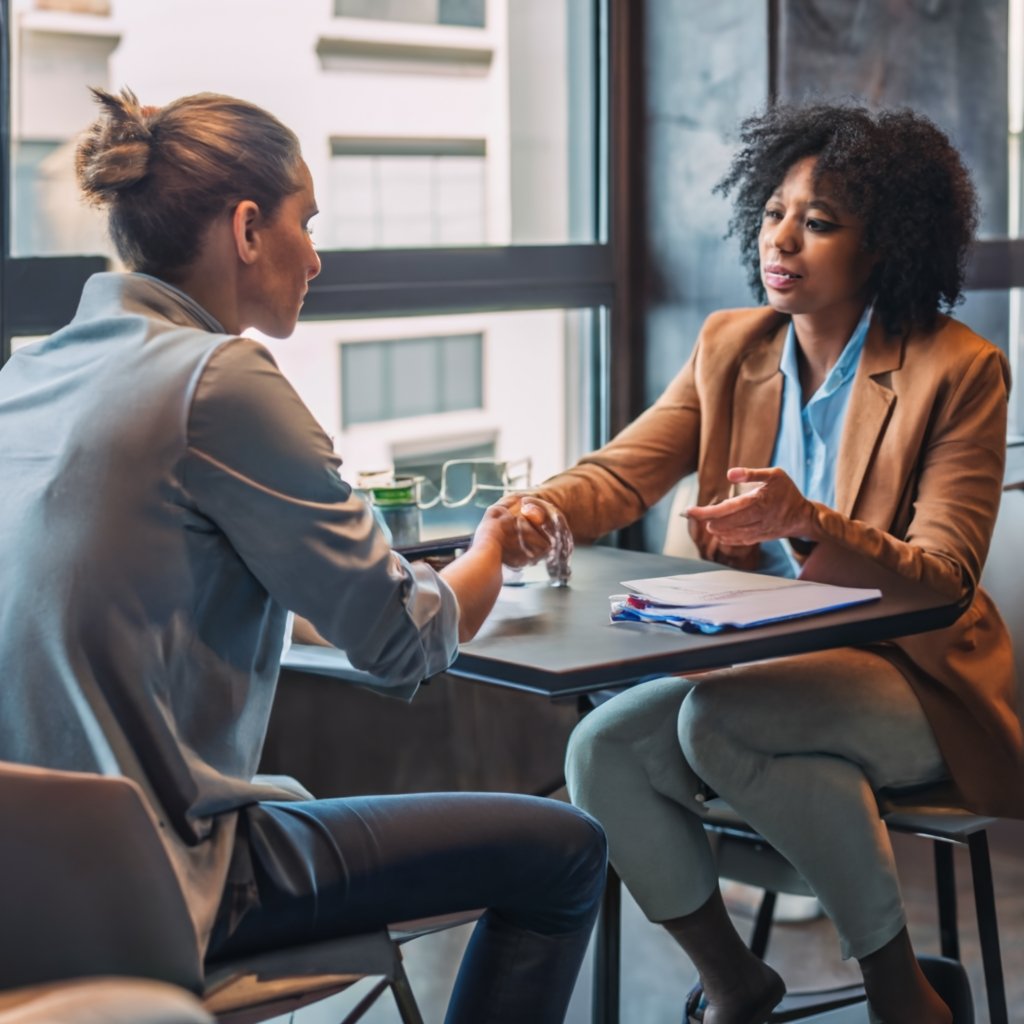 Immigration attorney in a formal office setting, pointing at and explaining the EOIR 33 form to a client, depicting professional legal consultation.