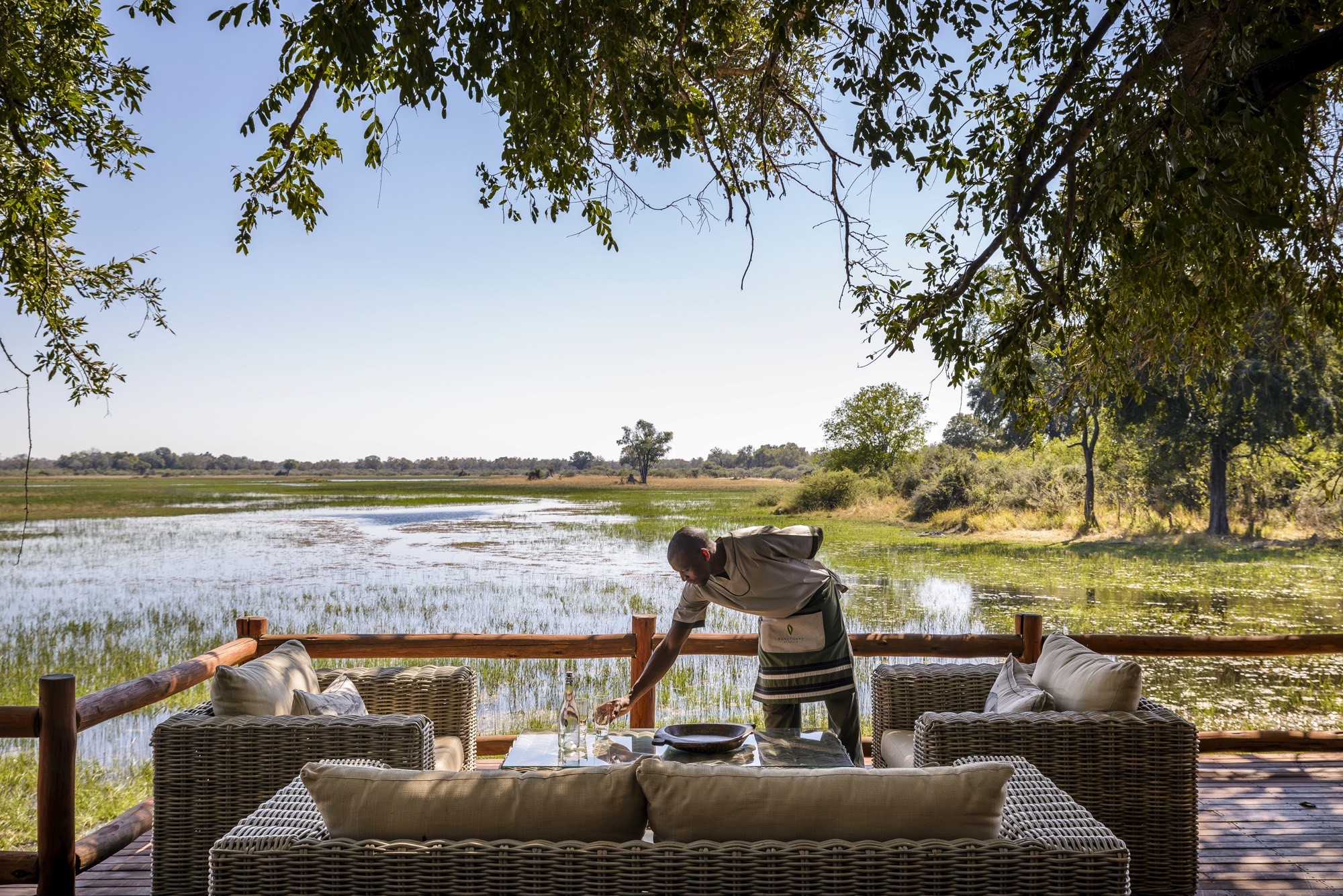 A host setting a deck table above the Delta's reedbeds