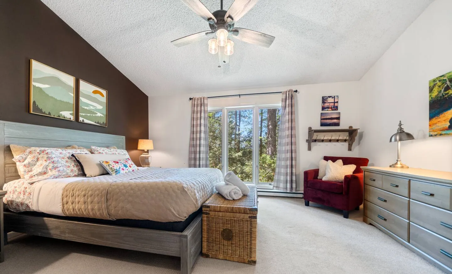 Primary bedroom with queen bed, desk and gray dresser at Lake Front, Lake Naomi