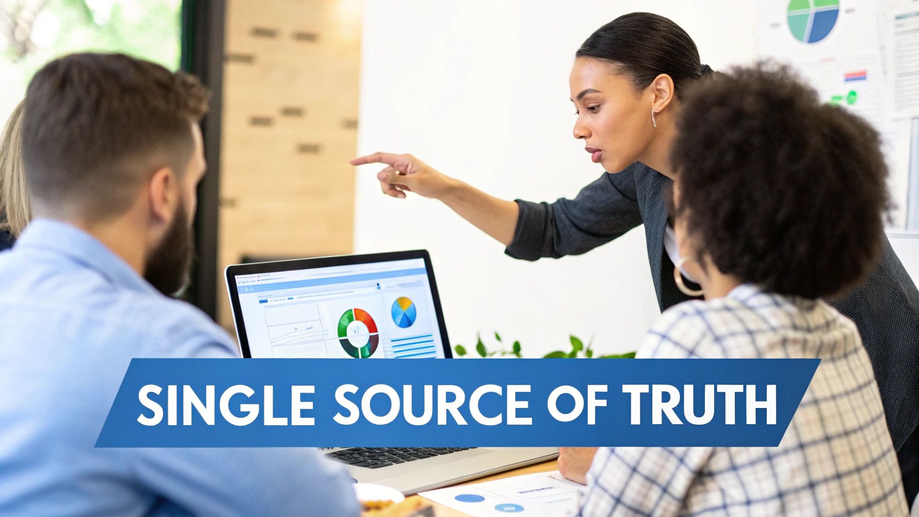 Diverse business professionals collaborating and analyzing data on a laptop with charts.