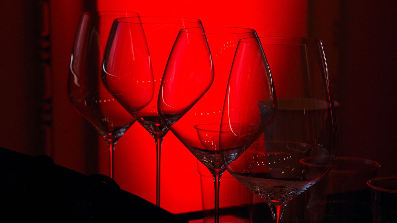 A thoughtful young person with dark hair gazes to the side, captured in soft black and white lighting.