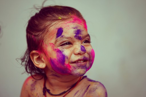 selective focus photography toddler girl with face paint