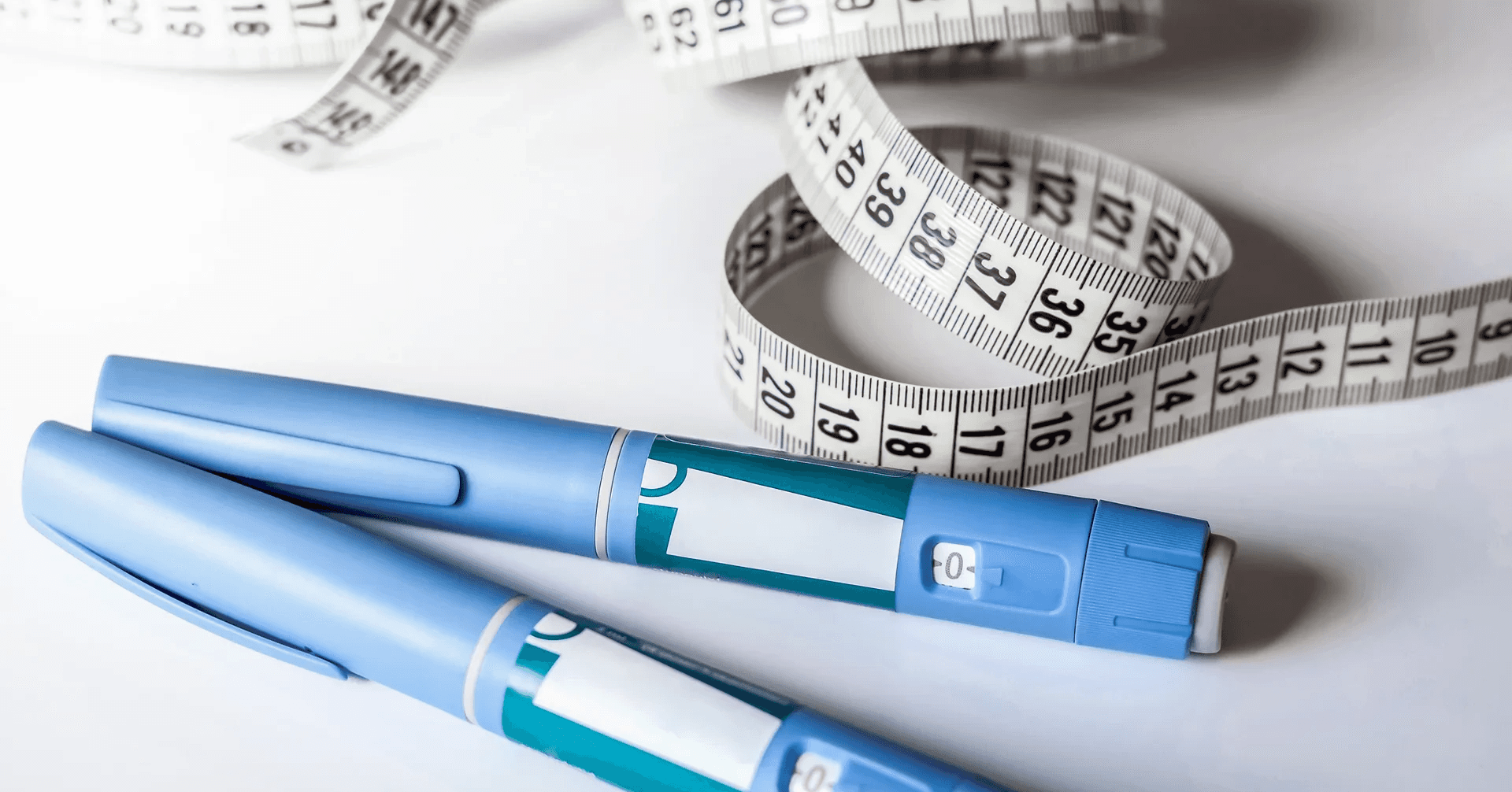 Medical pens and white measuring tape - How Can I Track My Semaglutide Progress?