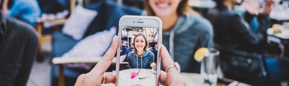 person taking photo of woman