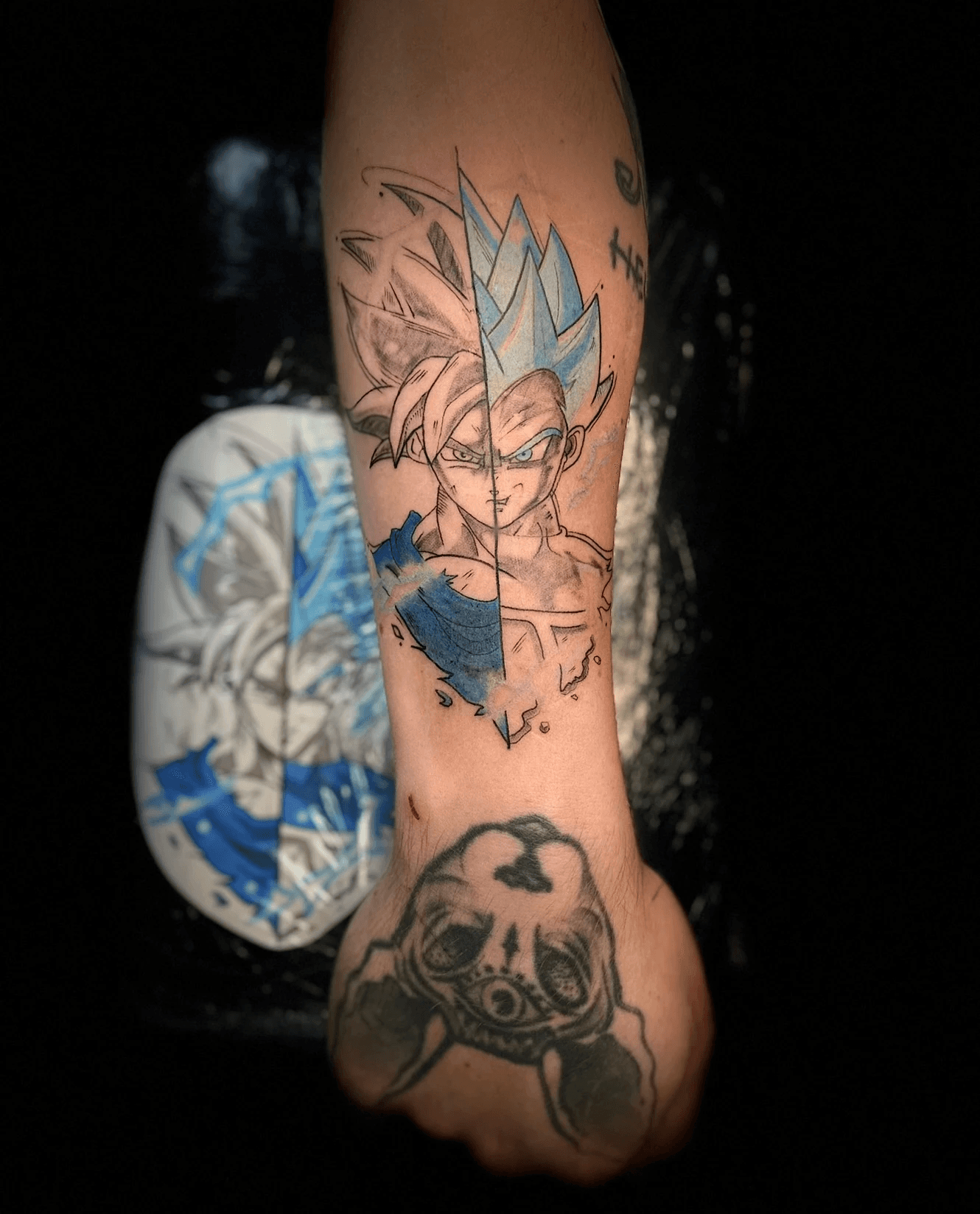 Realistic black panther tattoo on the upper arm, featuring detailed shading and contrasting eye colours, seamlessly blended into a starry night scene. Tattoo crafted by Jai at Bloodworks Tattoo Studio, Auckland.