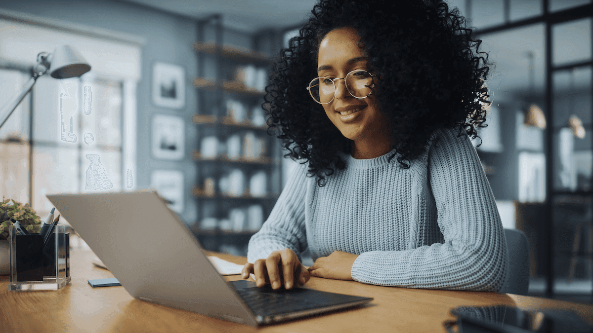 Smiling woman using her laptop