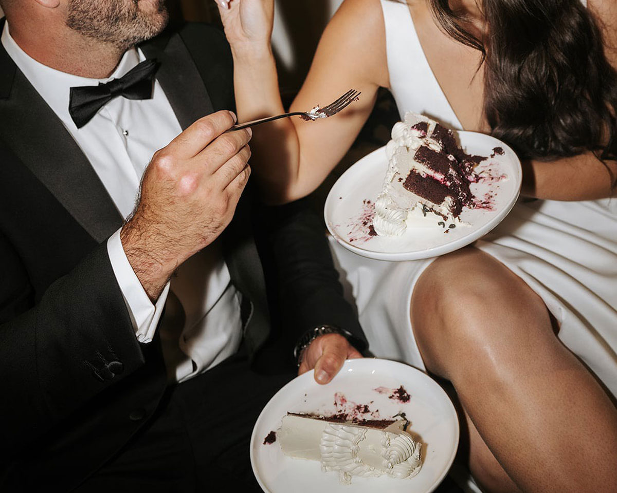 couple sharing first slice of wedding cake together