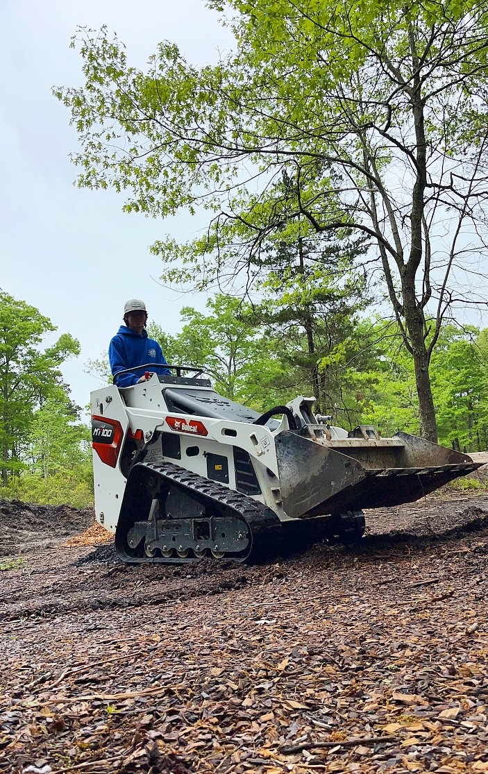 Kai operating a compact loader