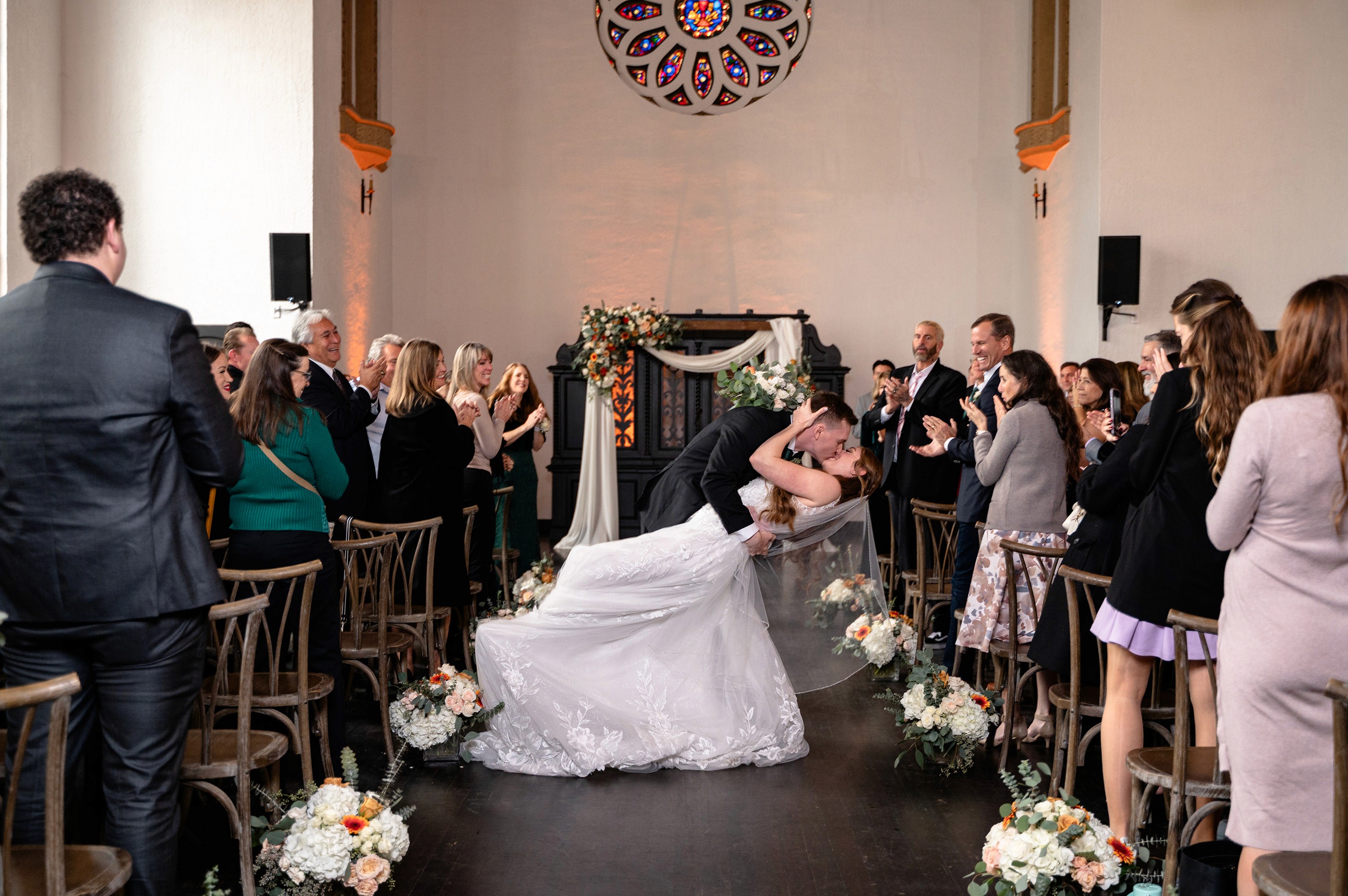 Flat lay wedding details with bouquet, rings, and sparkling bridal heels