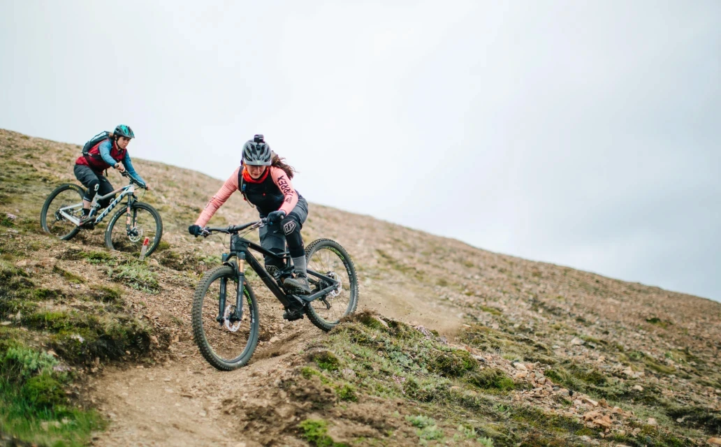 Two MTB riders going down mountain
