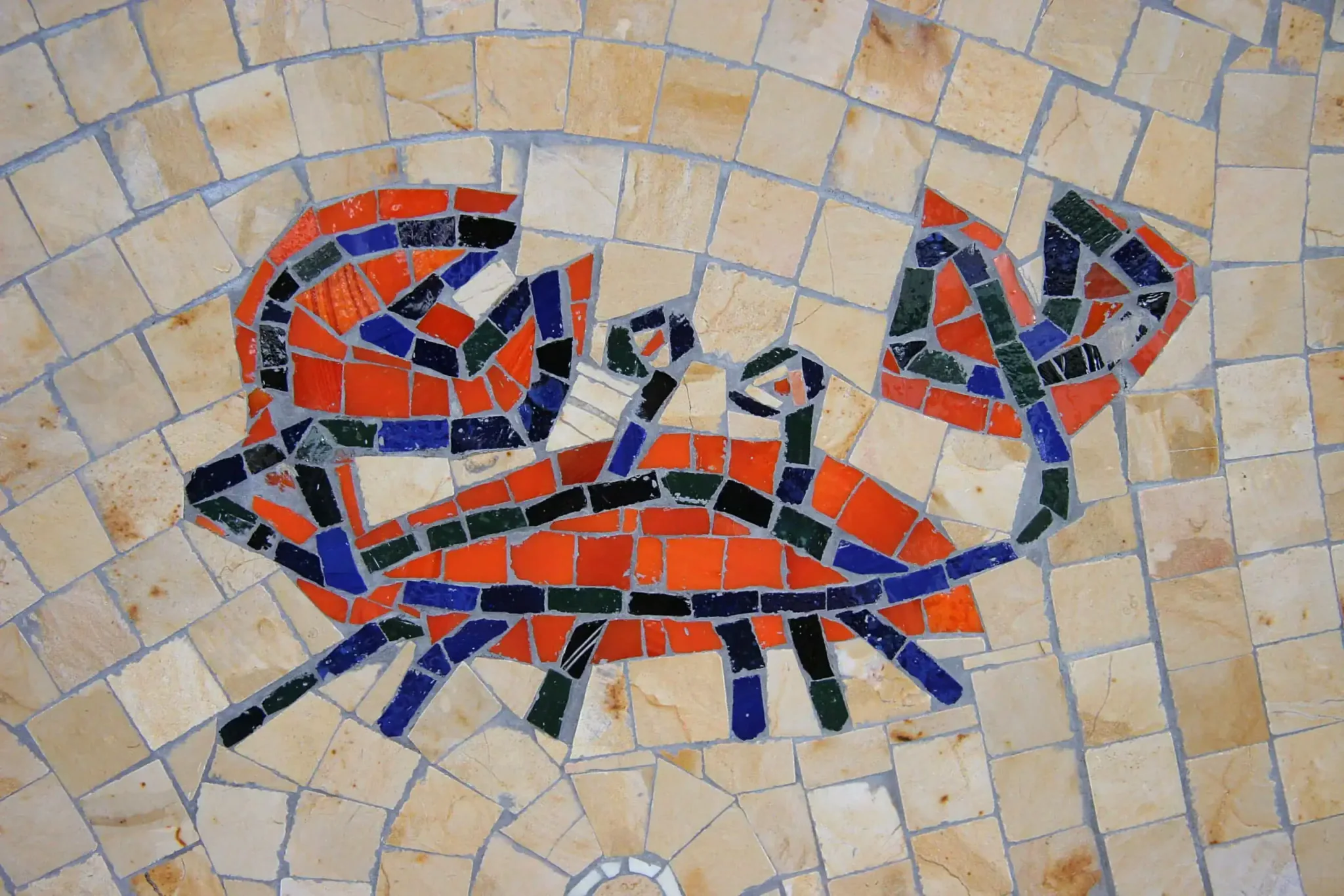 Mosaic mural of a crab at San Diego Airport, celebrating Pacific Ocean themes with vibrant tiles.