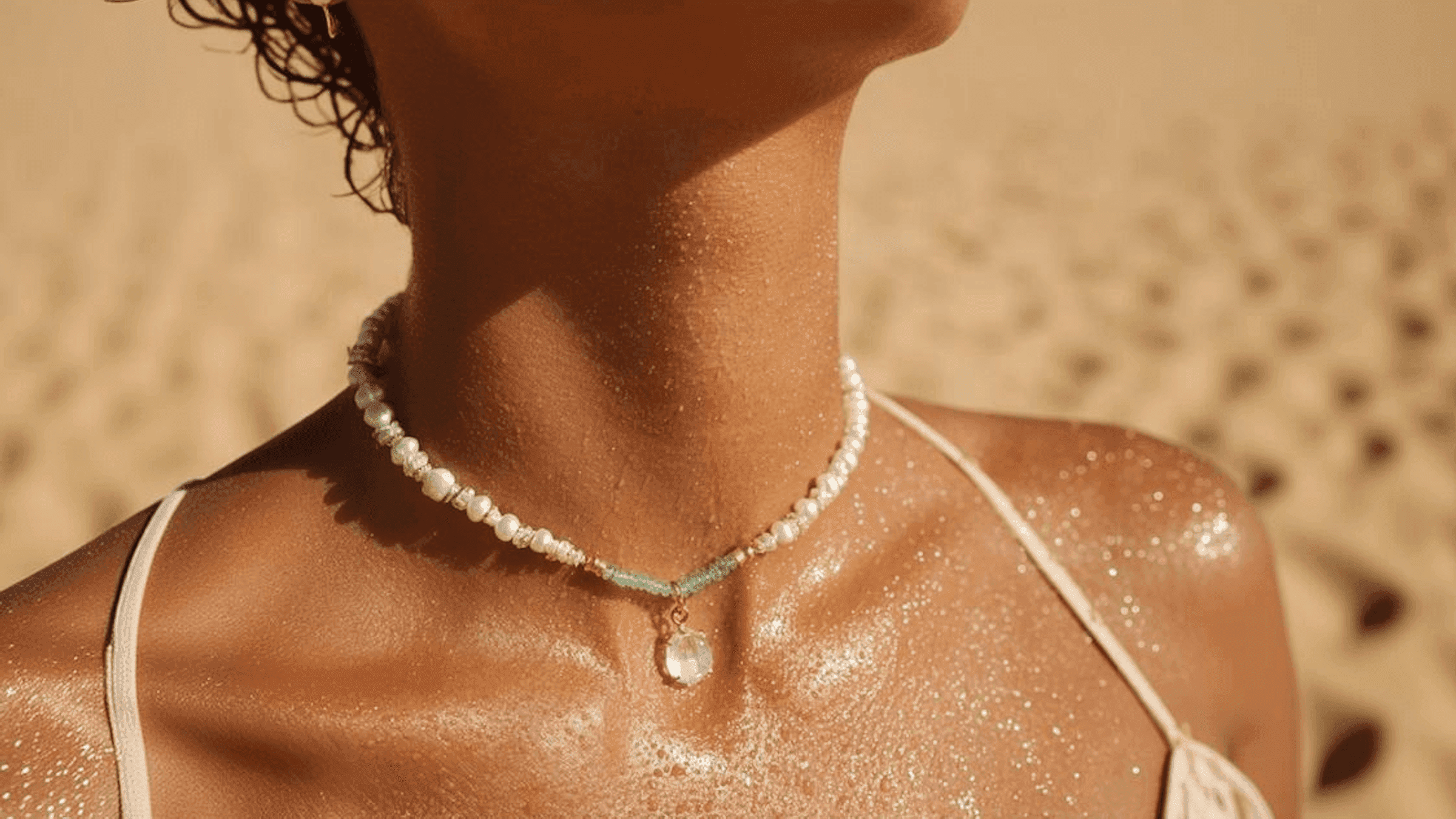 Close-up of a vintage orange car's front, featuring dual round headlights, a chrome grille, and a sleek, polished hood.