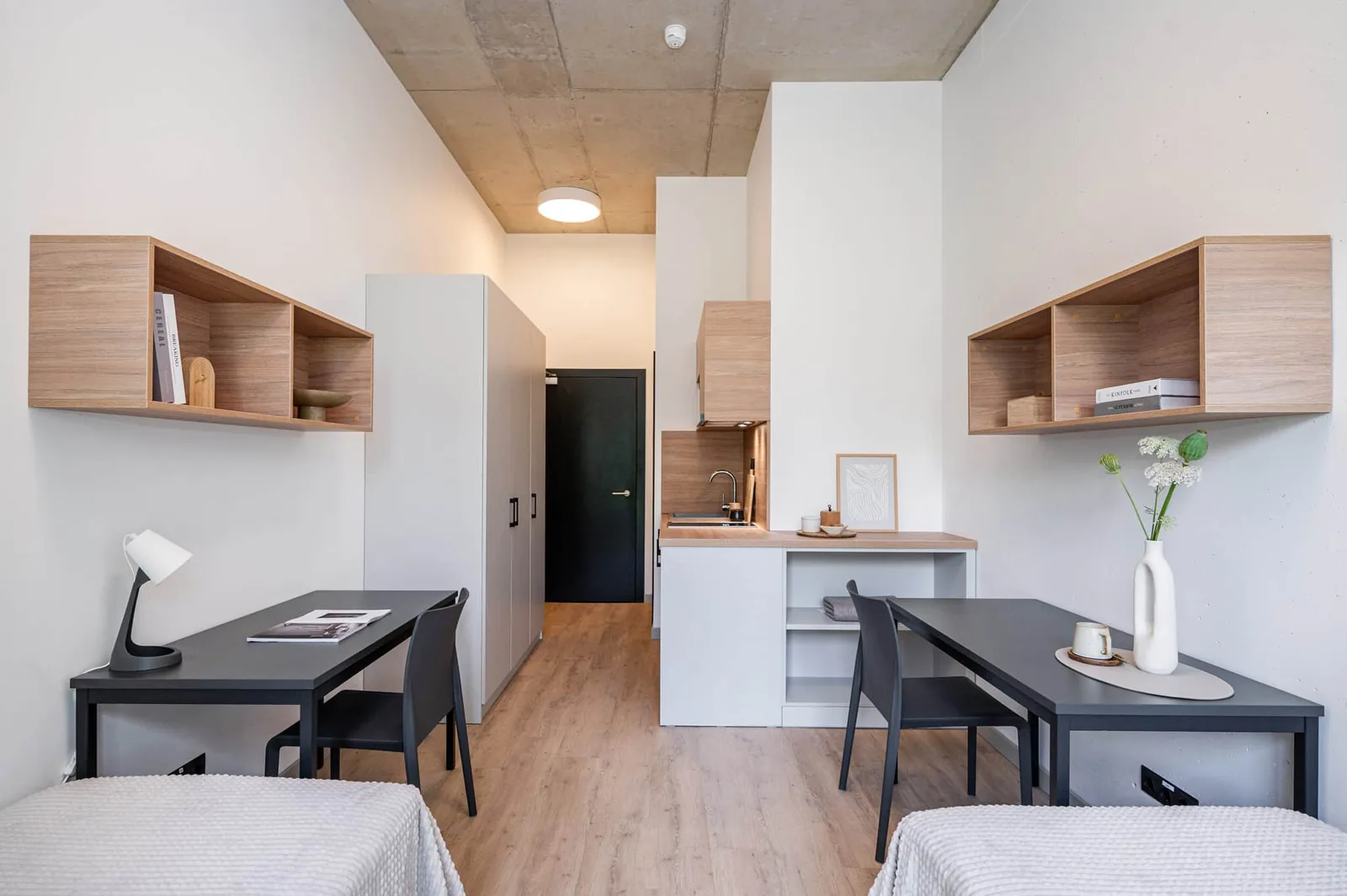 Twin Studio in Riga with two study desks, kitchenette and shared student living space