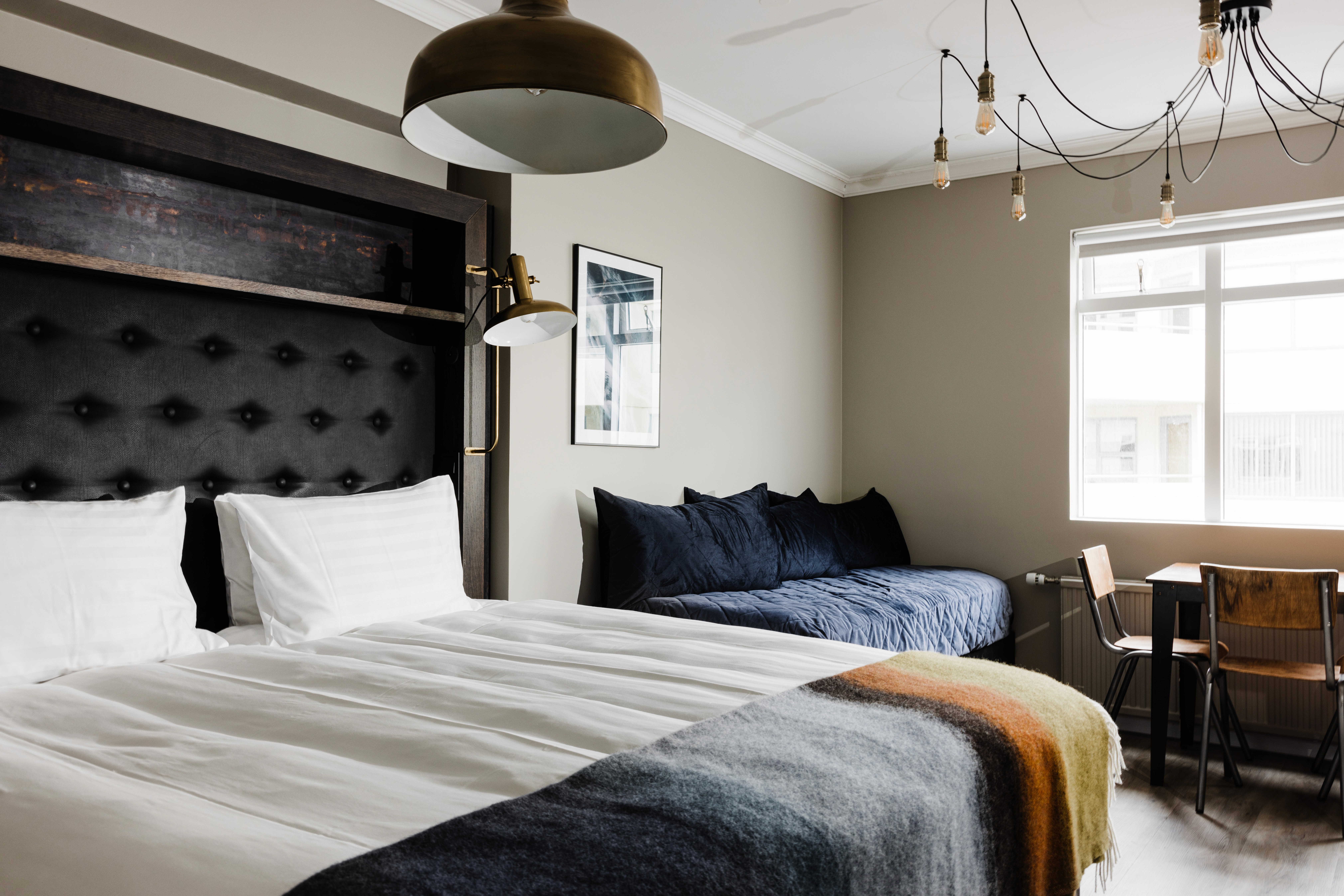 Warm and cozy room at ODDSSON Downtown Hotel with a window overlooking the street.