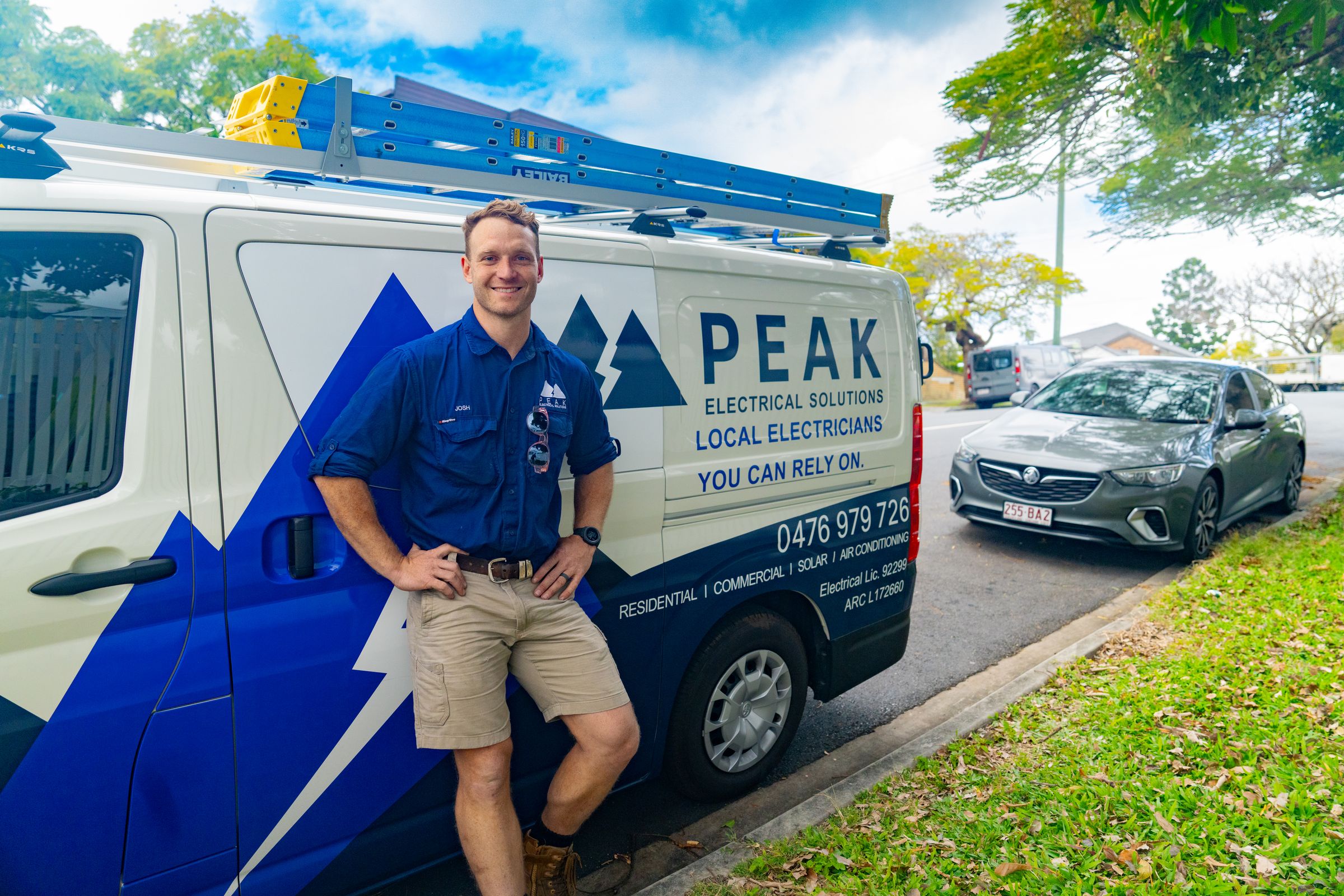 Josh from Peak Electrical Solutions beside the work van