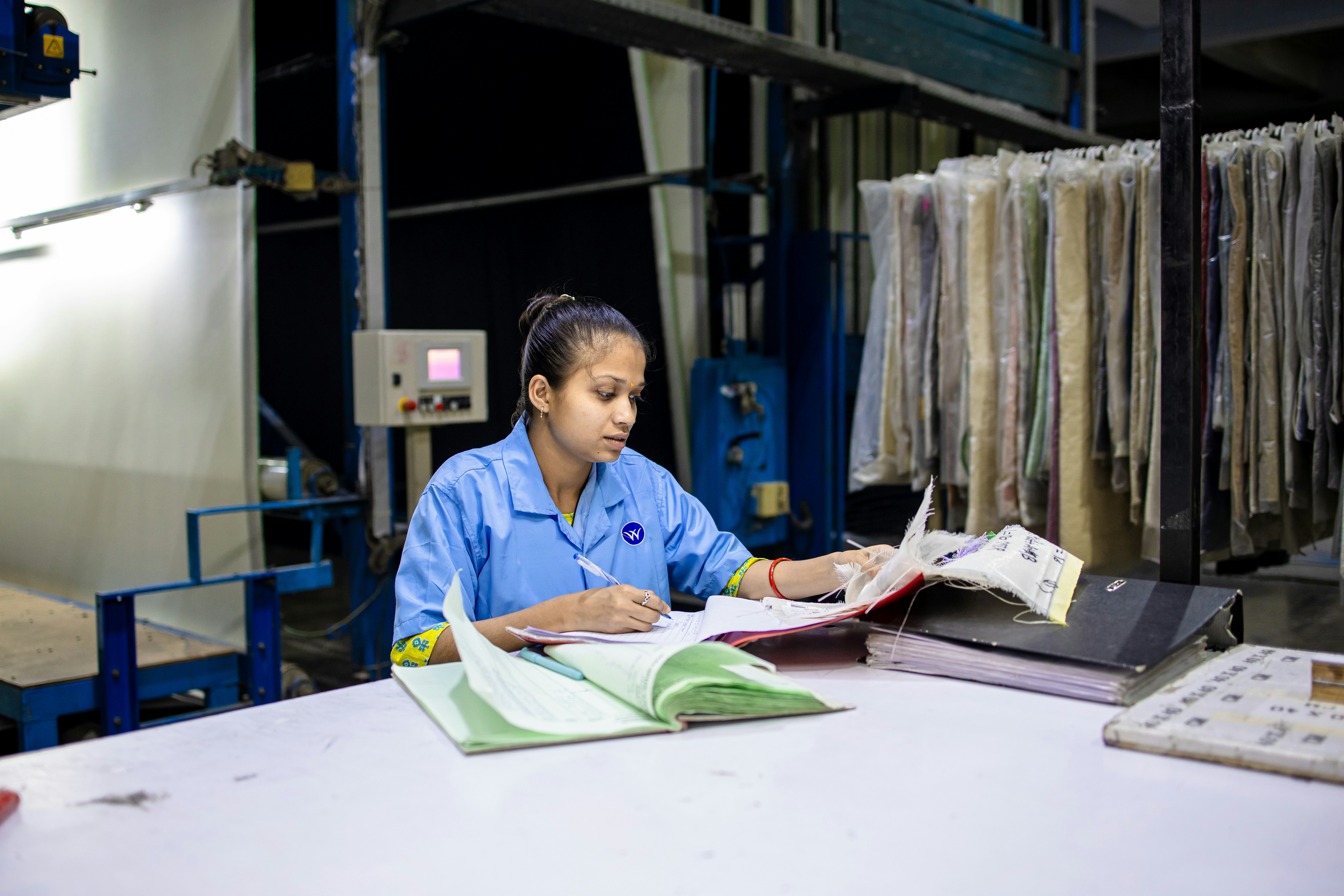 A woman is working in a textile factory.
