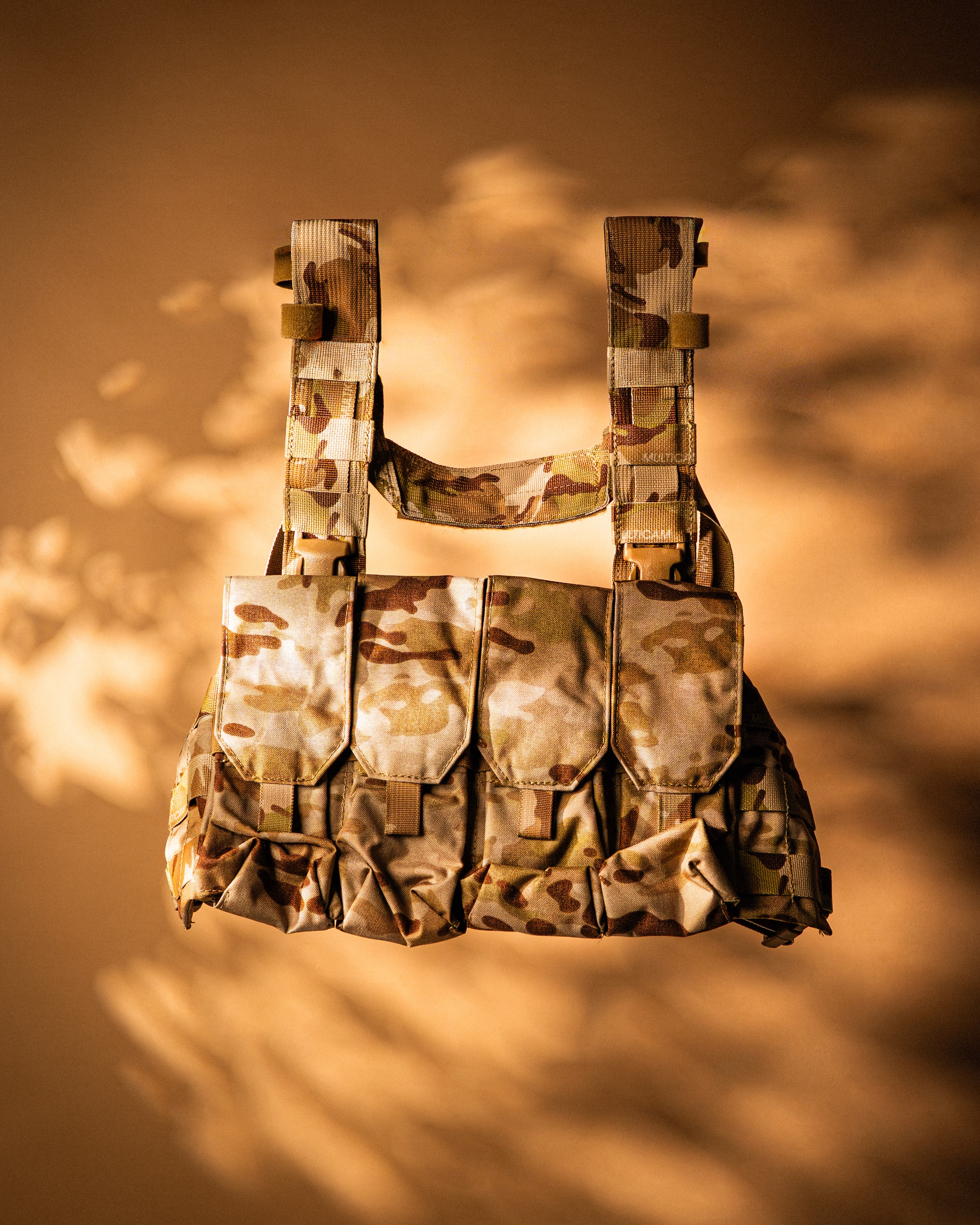Black and white photo of two people looking at a computer screen with papers on wall