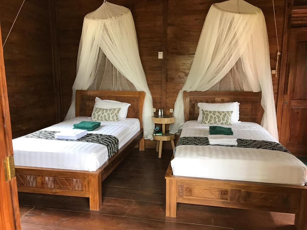 A-frame wooden cabin in a dense green forest.