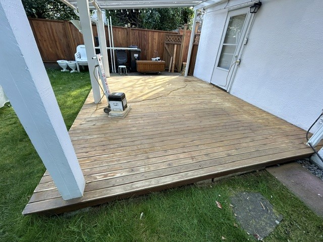 Heavily weathered exterior wood deck before restoration.
