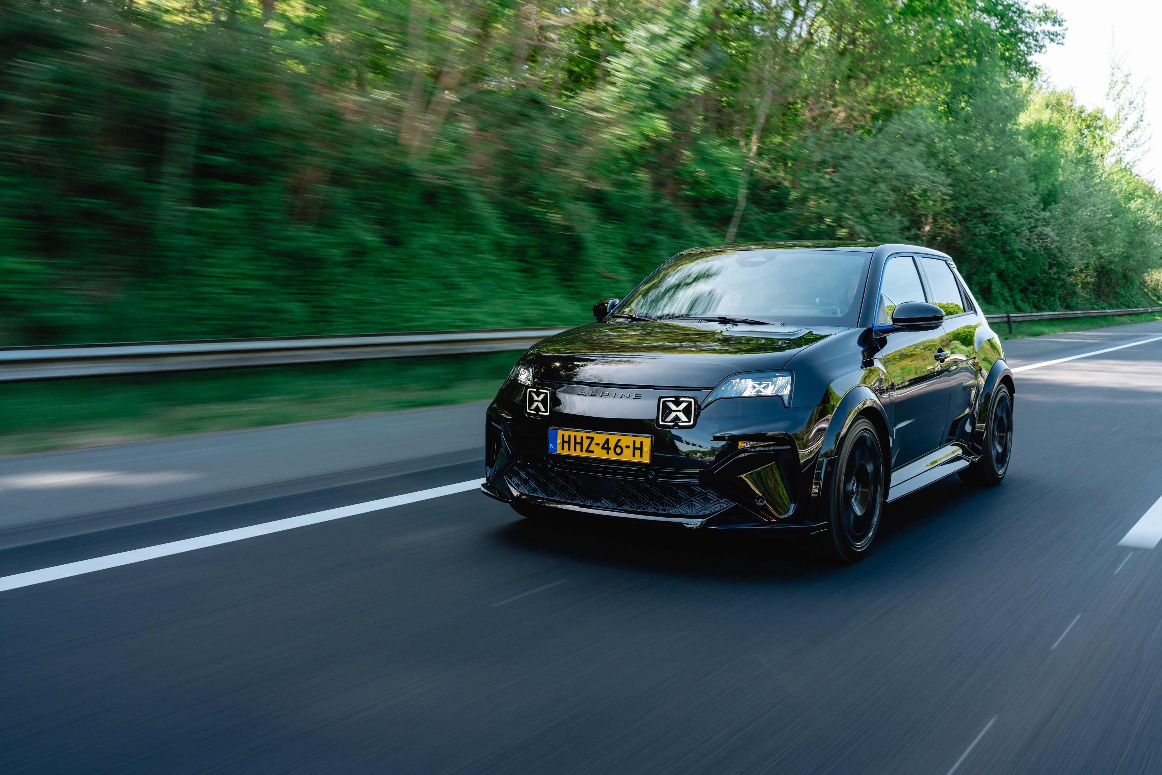 Lightyear 0 electric car showcased at its unveiling event in Spain, against a bright blue sky with scattered clouds, highlighting its futuristic design and aerodynamic lines.
