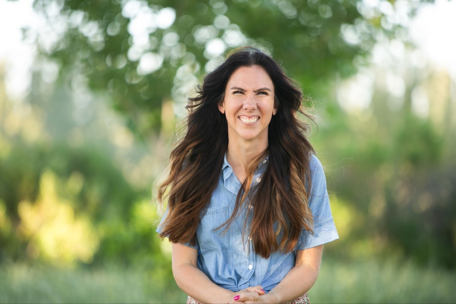 Melissa Schulz smiling outdoors, representing her calm and confident parenting approach.