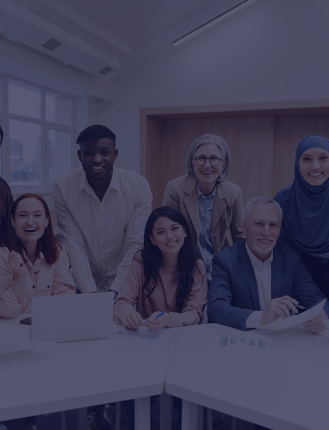 Diverse group of people smiling during a team workshop or training session